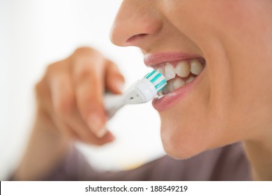 Closeup On Young Woman Brushing Teeth 