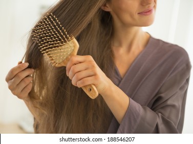 Closeup On Young Woman Combing Hair