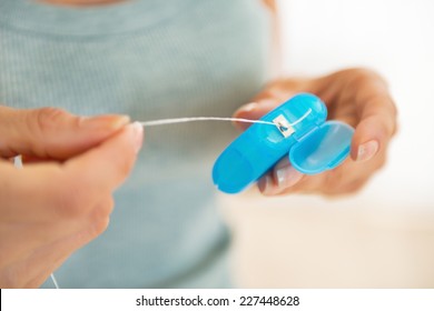 Closeup On Young Woman With Dental Floss