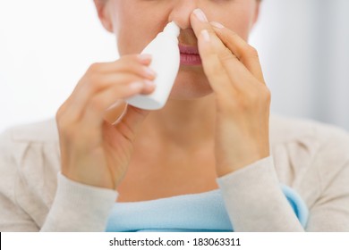 Closeup On Young Woman Using Nose Drops