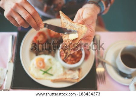 Closeup on a young woman's hands as she is having breakfast