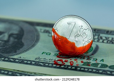 Close-up of one ruble coin in blood on dollar bills. The concept of depreciation, sanctions, financial crisis, war.