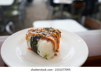 A Closeup Of A Onigiri Rice Ball With Spicy Mayo And Furikake Looking Yummy