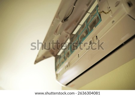 Close-up of Open Air Conditioner Unit with Visible Filters and Components