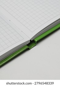 Close-up of an open checkered notebook or copybook on a white background