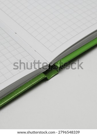 Close-up of an open checkered notebook or copybook on a white background