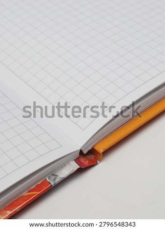 Close-up of an open checkered notebook or copybook on a white background