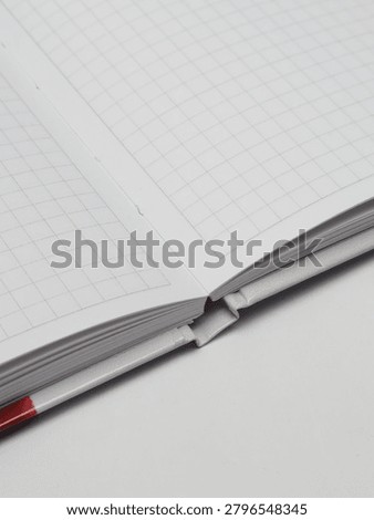Close-up of an open checkered notebook or copybook on a white background