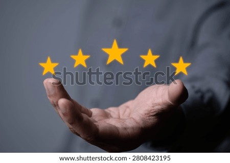 Close-up of an open hand displaying five glowing star rating icons, symbolizing customer satisfaction, positive feedback, quality service, online review, user experience, business evaluation concepts.