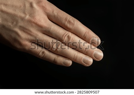 Close-up of an open human hand extended for a handshake on a black background. Perfect for business, agreement, partnership and professional connection concepts