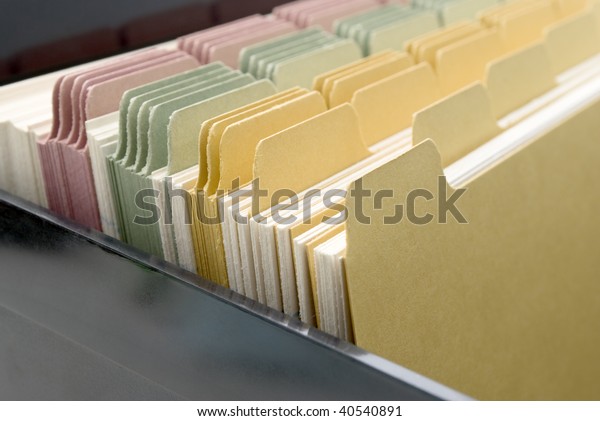 Closeup of an\
opened box of index cards.  Black box, white cards with dividers\
coloured pink, green and\
yellow.