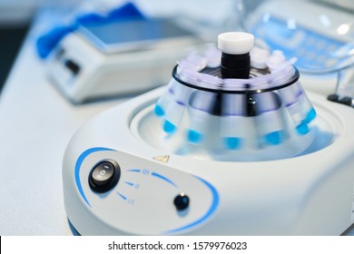 Close-up of opened laboratory centrifuge with samples inside of rotating units used for separating liquids.Close up of a chemist using a centrifuge rotor in lab  for medical and scientific research.