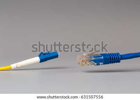 Close-up of optical patch cord lc and copper cable with plug rj45