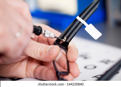 Closeup of optician's hands repairing new glasses - Powered by Shutterstock