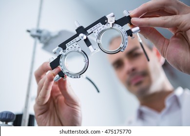 Close-up of optometrist holding messbrille in ophthalmology clinic