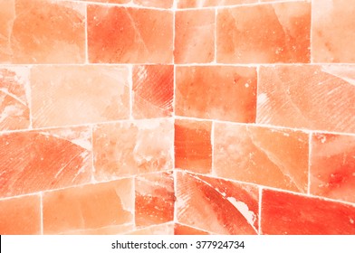 Close-up of orange salty wall inside sauna room as healty and energy concept