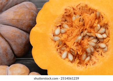 Close-up of an orange-coloured nutmeg pumpkin. The pumpkin is photographed from above. It is cut open in the centre and you can see the seeds and the flesh. - Powered by Shutterstock