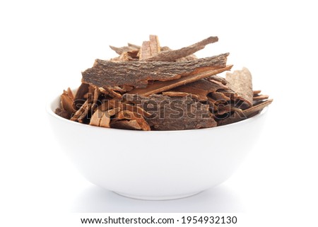close-up of Organic cinnamon ( Cinnamomum verum) or dalchini on a ceramic white bowl. Pile of Indian Aromatic Spice.
