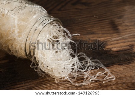 Closeup of organic kelp noodles in a glass mason jarl on weathered wood