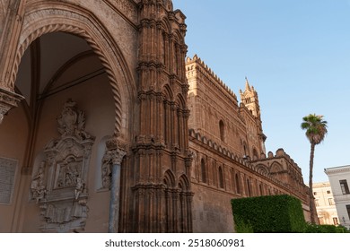 Close-up of the ornate facade and arched entrance of Palermo Cathedral in Sicily, highlighting its intricate Norman architecture and decorative elements - Powered by Shutterstock