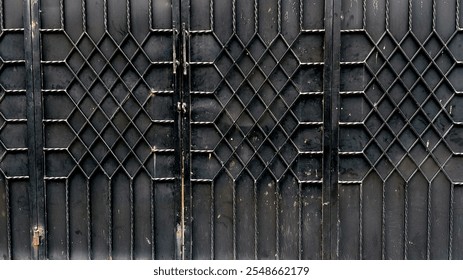 A close-up of an ornate metal gate with a diamond lattice pattern, showcasing intricate details and a weathered texture. - Powered by Shutterstock