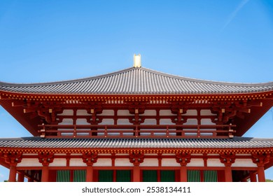 A close-up of the ornate roof of Heijō Palace in Nara, Japan, showcasing traditional Japanese architecture against a clear blue sky. - Powered by Shutterstock