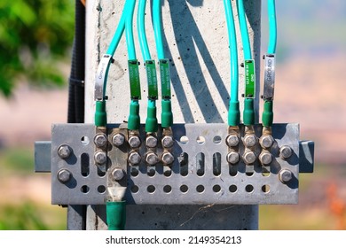 Close-up Of Outdoor Ground Rod Of Cell Phone Tower With Cable