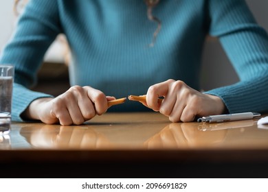 Closeup of outraged female employee breaking pencil siting at office desk. Angry businesswoman boss or leader suffer from nervous breakdown at workplace. Stress at work, bad news and serious problems - Powered by Shutterstock