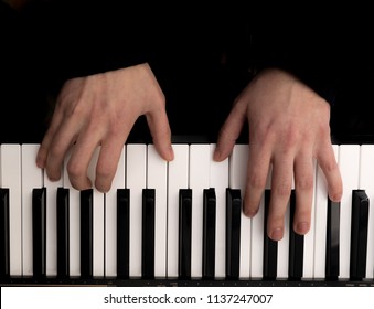 Close-up Overhead View Of Hands Playing The Piano