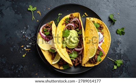 A close-up overhead view of three authentic Mexican tacos filled with seasoned meat, onions, and cilantro, topped with creamy guacamole.