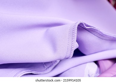 Close-up of Overlock stitch and straight stitch on purple dress