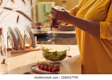 Closeup Of Overweight Black Woman Cooking Healthy Meal In Kitchen Lit By Sunlight, Copy Space