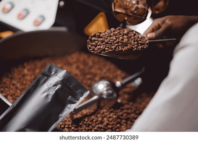 Closeup packing fresh coffee in bag takeaway package at roasting factory. - Powered by Shutterstock