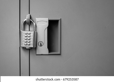Closeup padlock with key number hanging on locker for concept technology data log security on black and white.