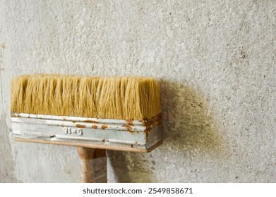 close-up paintbrush with natural bristles metal ferrule shows signs of rust wooden handle DIY home improvement painting or renovation tools manual labor artistry restoration hard work transformations - Powered by Shutterstock