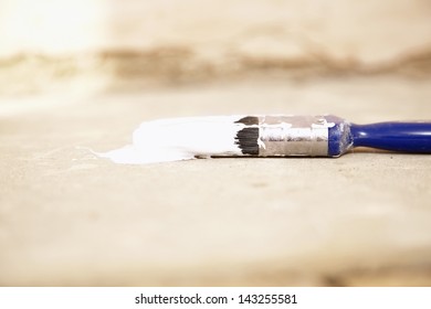 Closeup Of Paintbrush On Painting Tarp