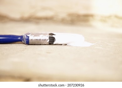 Closeup Of Paintbrush On Painting Tarp