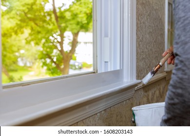 Closeup Paintbrush A Wooden Window With White Paint Trim