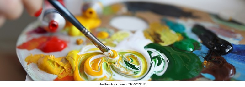 Close-up of painter combine colours on palette. Creamy oil paints on surface. Painter equipment for work. Masterpiece idea and creativity flow. Artistry and job concept - Powered by Shutterstock