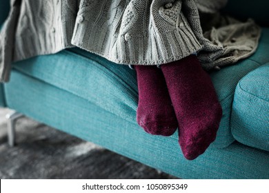 Closeup pair of legs on the sofa