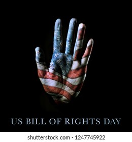 Closeup Of The Palm Of A Hand Patterned With The American Flag And The Text US Bill Of Rights Day Written On A Black Background