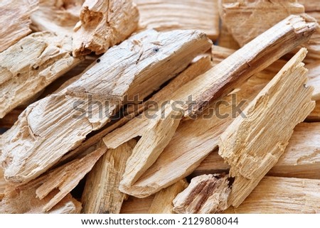 Close-up of Palo Santo wooden sticks (Bursera graveolens), an organic holy tree in Latin America. Traditional incense used for meditation, relaxation, healing, cleansing home. Top view.