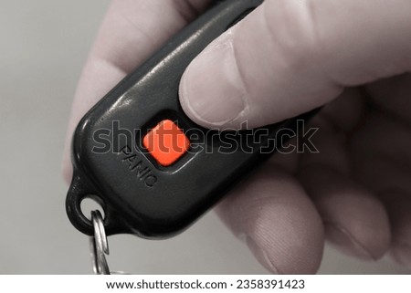 Closeup of Panic Button on key fob for car safety system on keys