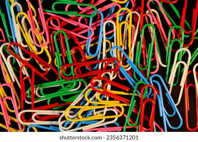 Closeup paperclips with various colors and black background