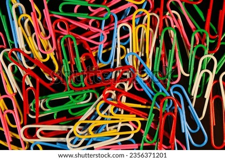 Closeup paperclips with various colors and black background