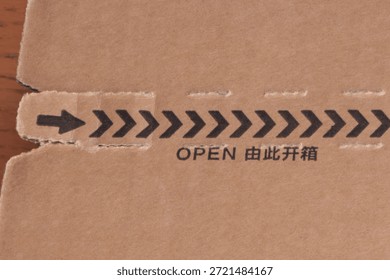 Close-up of a parcel from China labeled “OPEN” in both English and Chinese characters, symbolizing international trade, the import and export of Chinese goods, global logistics, and e-commerce supply chains.