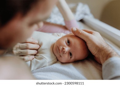 Close-up of parents cuddling their newborn baby. - Shutterstock ID 2300598111