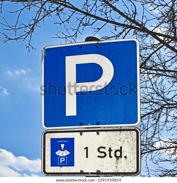 Close-up of a\
parking lot sign with an additional note on a limited park duration\
of one hour in Berlin,\
Germany