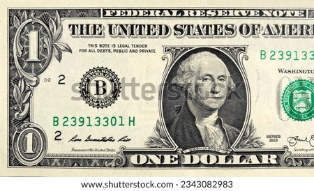 A close-up of a part of a $1 bill. View from above. One US dollar. The American national currency. Economics and finance. Cash banknotes. Cash dollar bills.