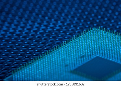 Close-up of a part of a microprocessor in soft focus under high magnification. Details of a computer component under a microscope in tech blue light.